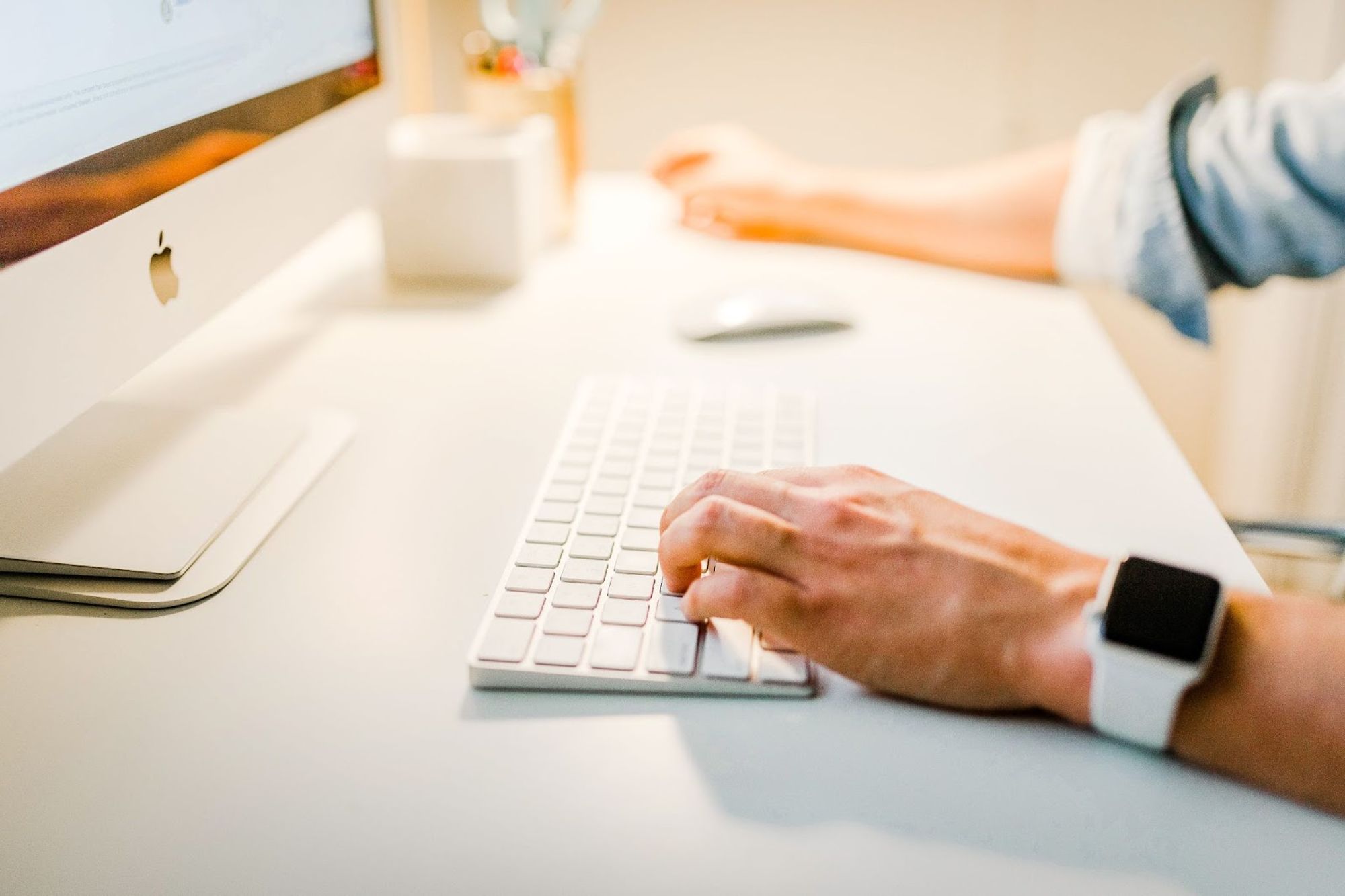 Close-up of hands typing on a keyboard