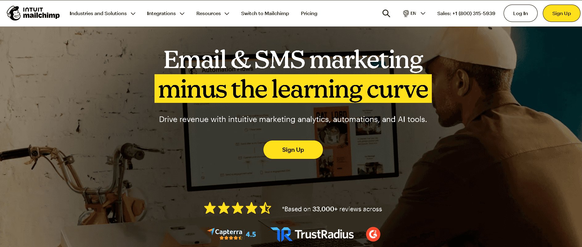 Mailchimp homepage hero section showcasing its intuitive email and SMS marketing automation platform interface with user review badges.