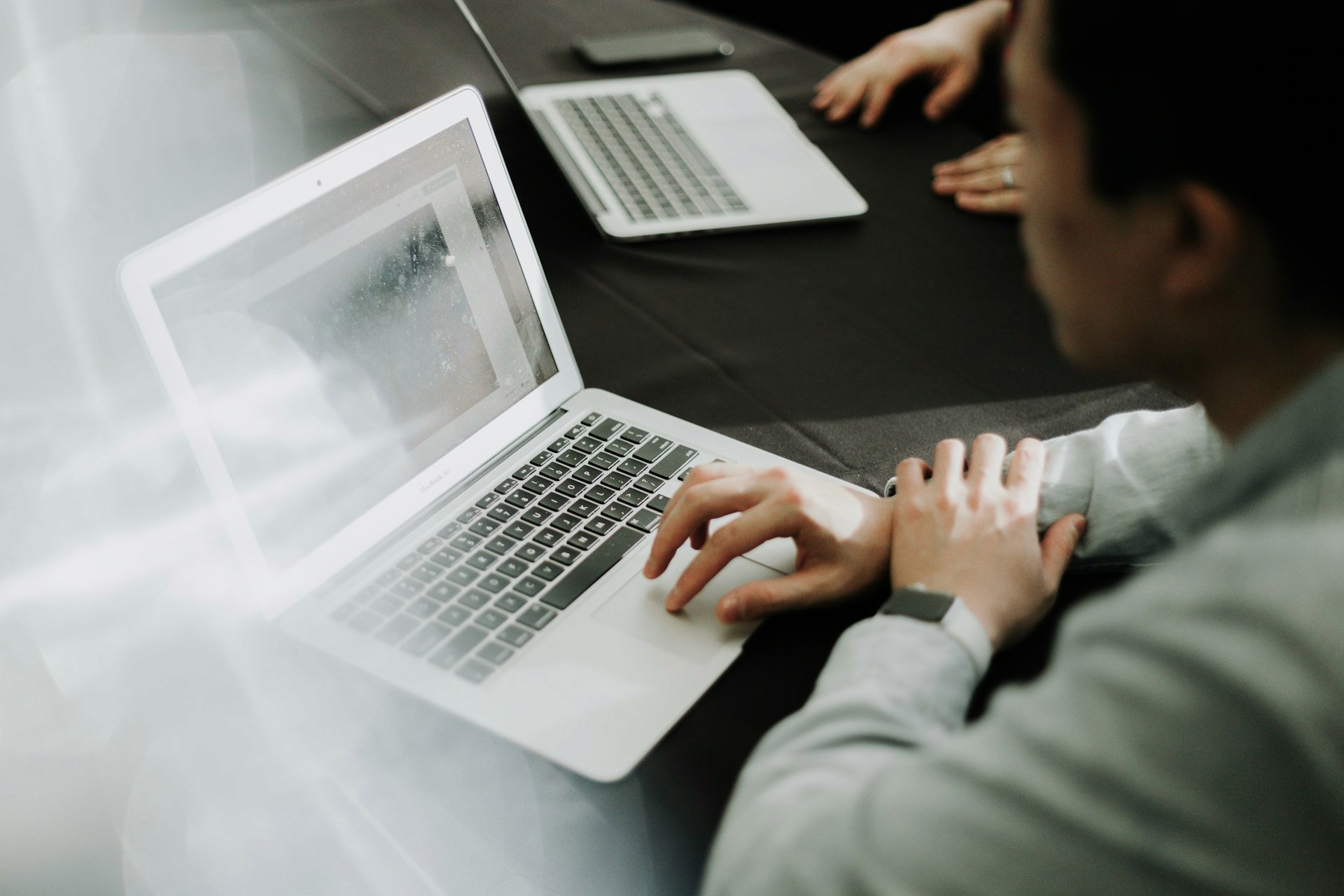 A marketer setting up an inbound marketing software automation funnel on a laptop.