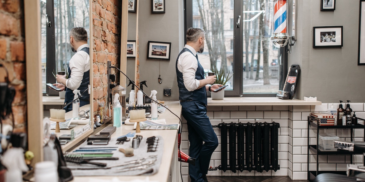 Barber standing at counter in a barbershop