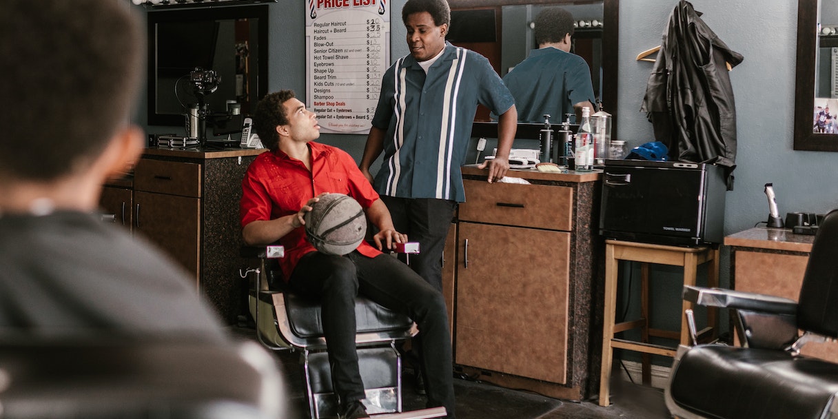 Two men talking in a barbershop