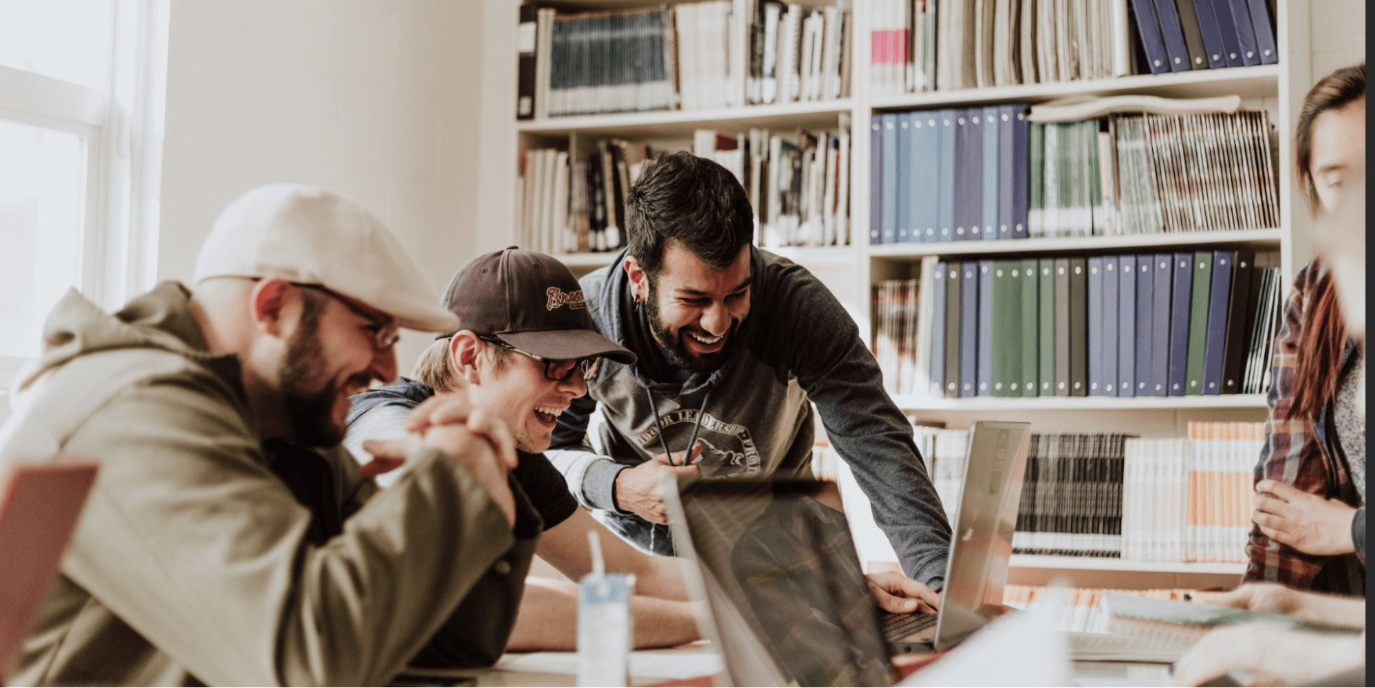 Students laughing together in a library