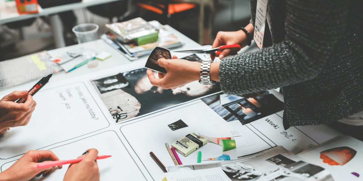 People reviewing marketing mockups on a table