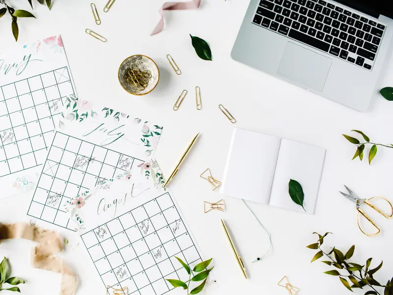 Flat lay of calendar pages and stationery