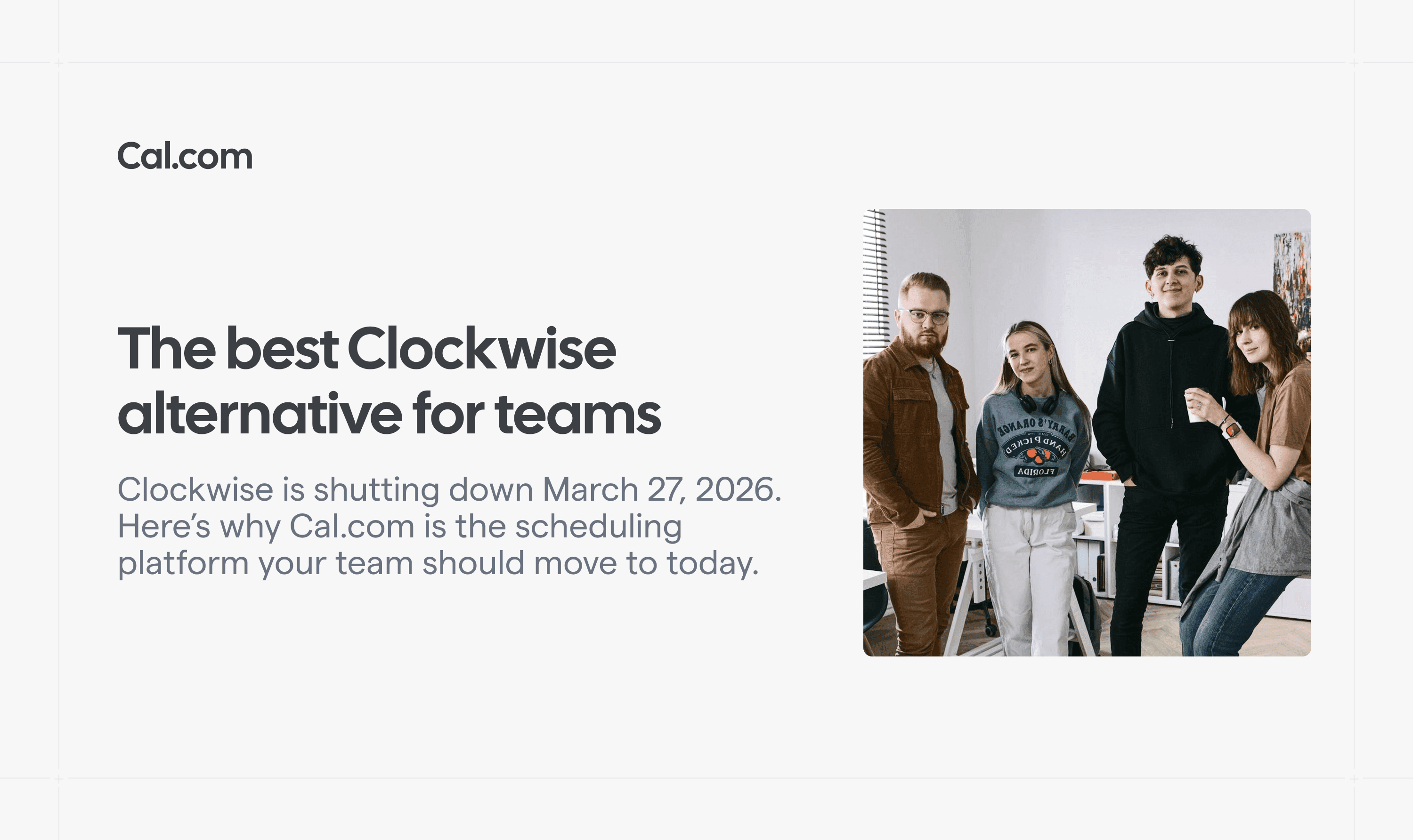 Four coworkers standing together in an office