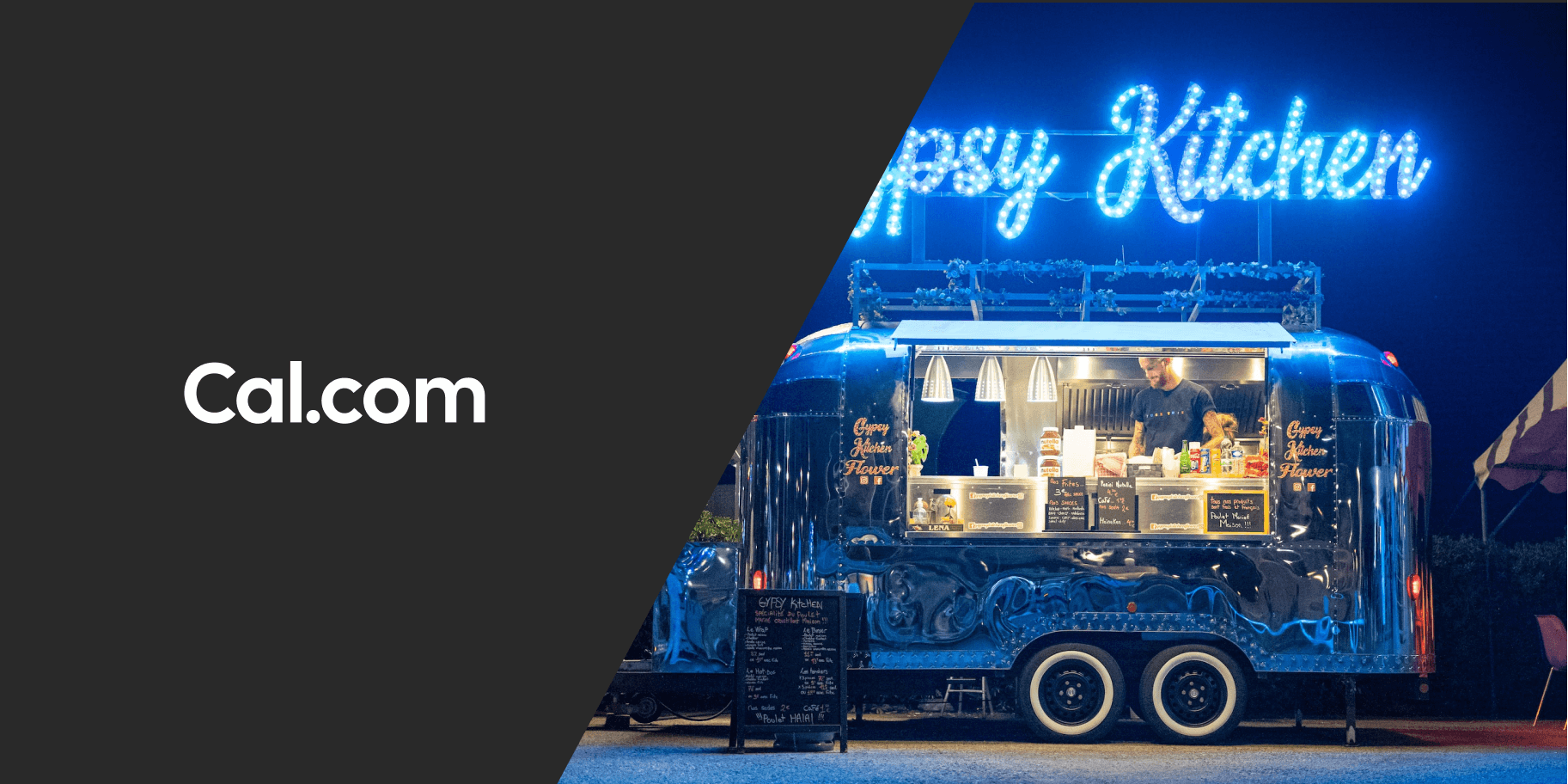 Food truck lit up at night beside Cal.com logo