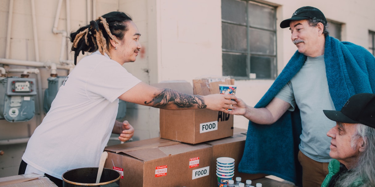 Volunteers distributing food aid boxes