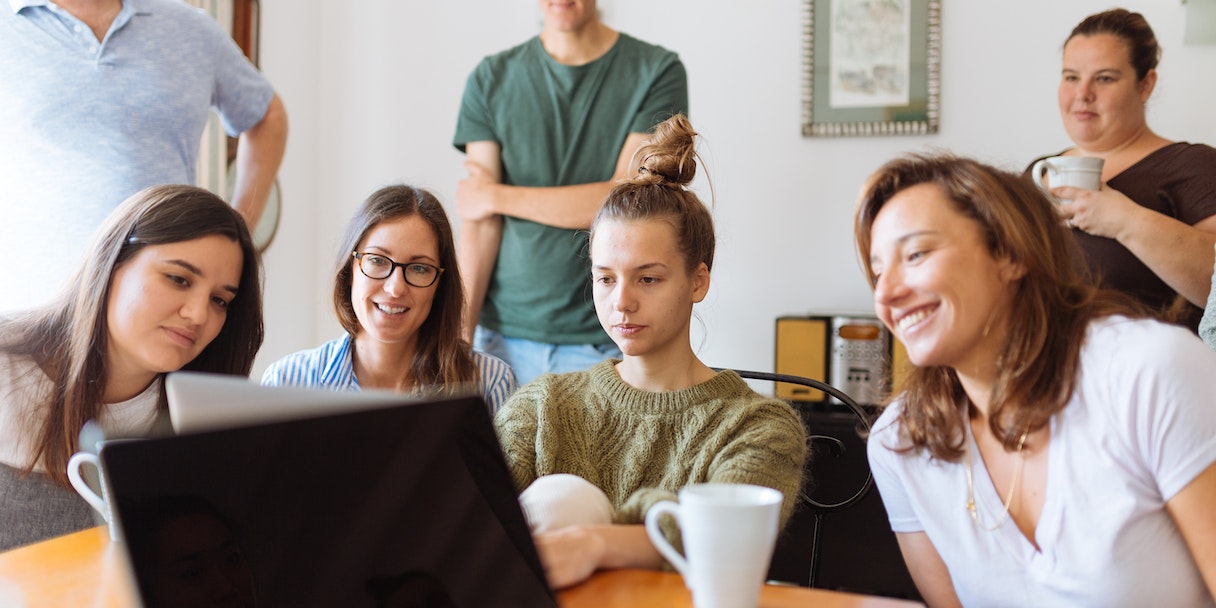 Family gathered around a laptop together