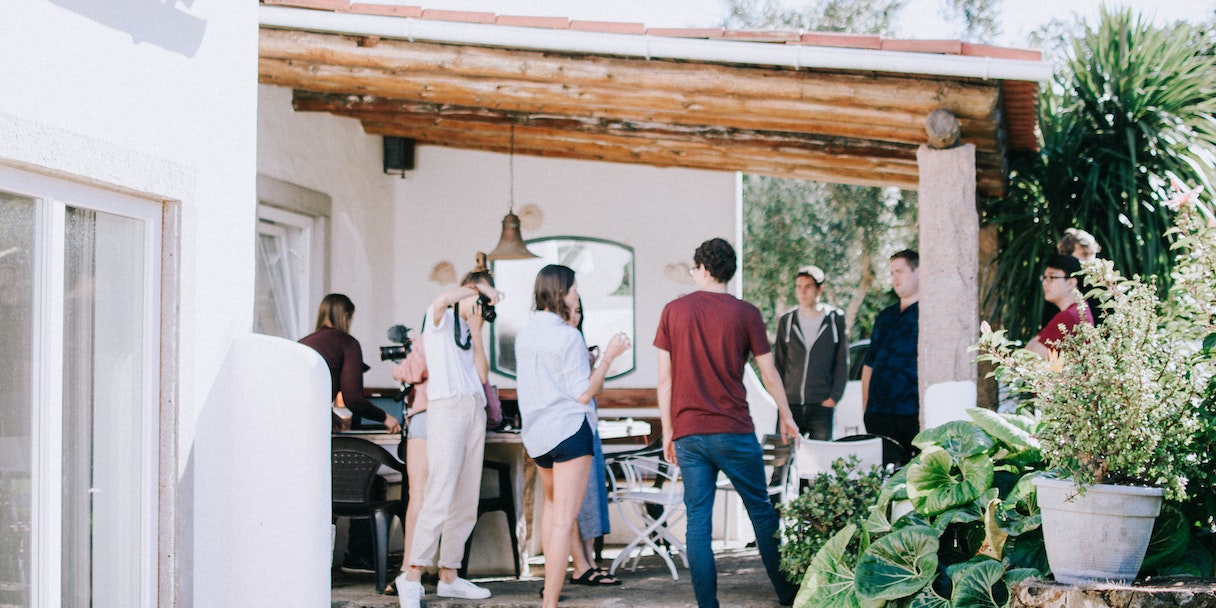 Group gathered outdoors under a patio