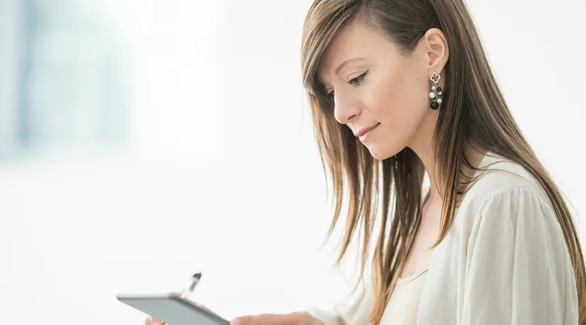 Woman using tablet in bright office
