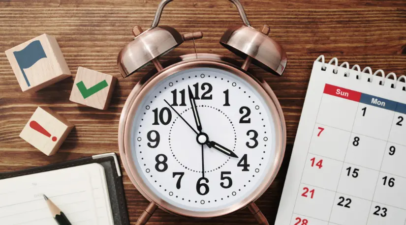 Alarm clock, calendar, and to-do blocks on desk