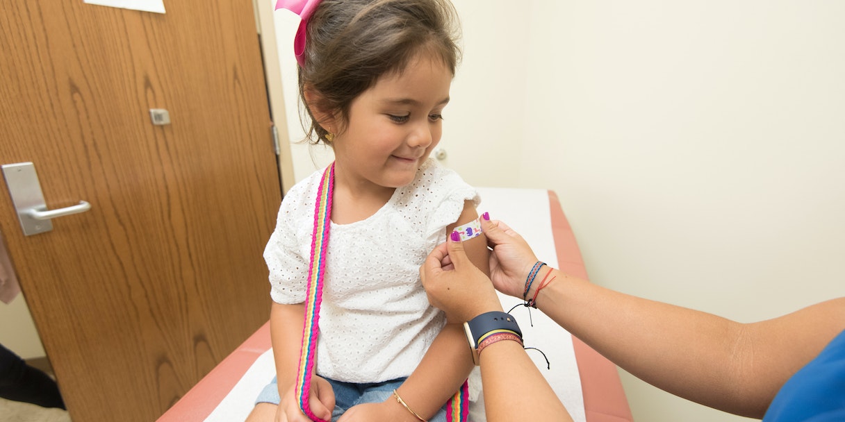 Child receiving a bandage at a medical visit