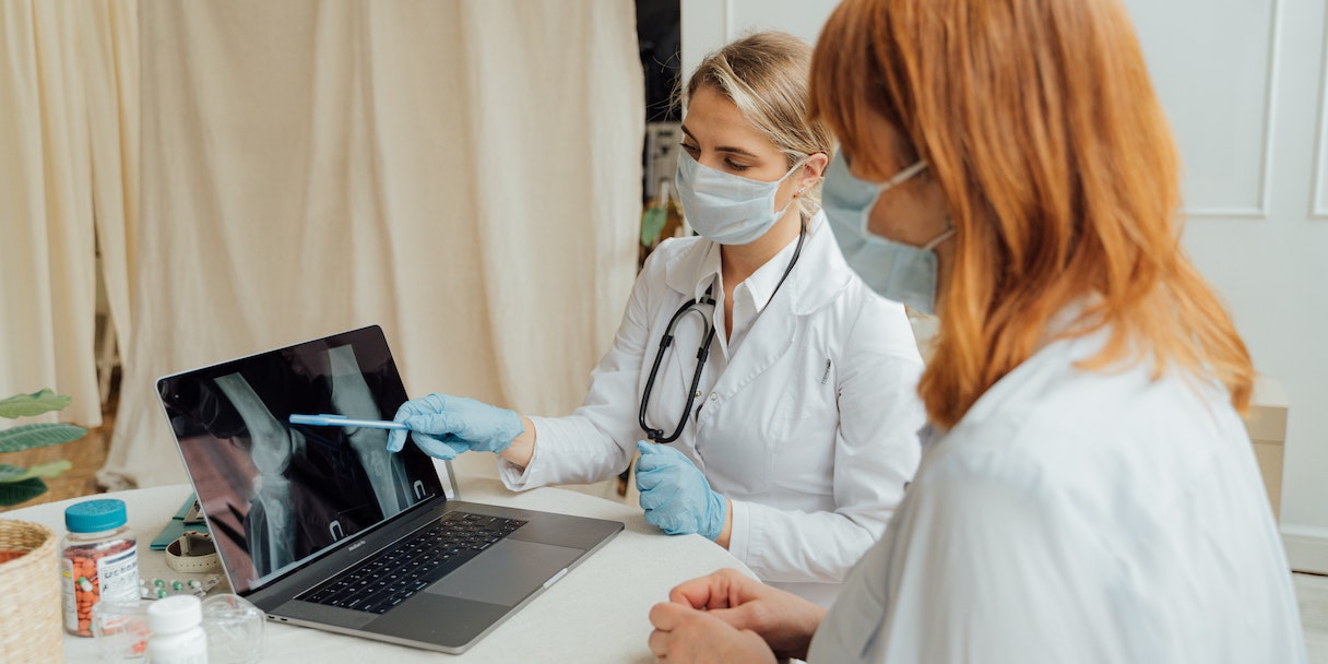 Doctors reviewing an x-ray on a laptop