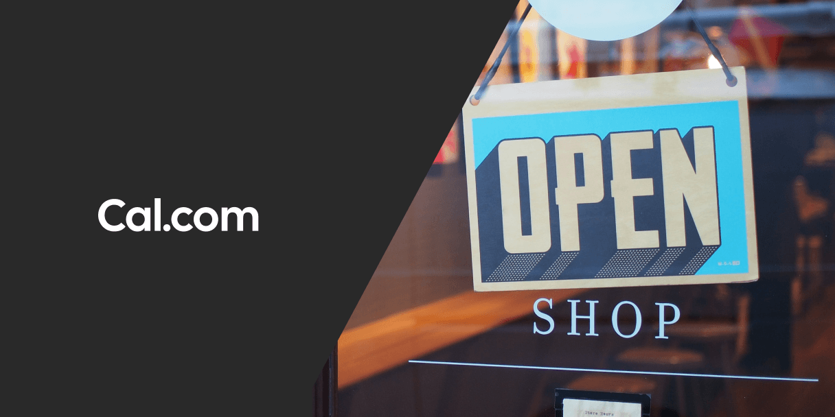 Cal.com logo beside an Open sign in a shop window