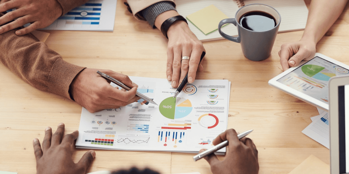 Team reviewing sales charts and reports at a table