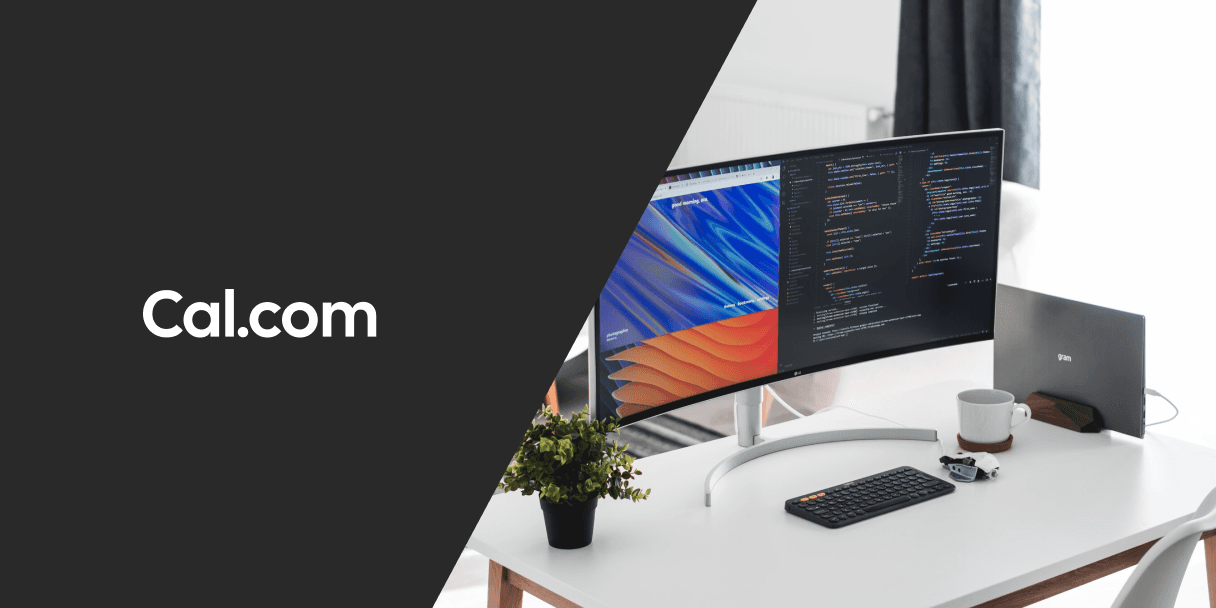Home office desk with dual monitors and Cal.com logo