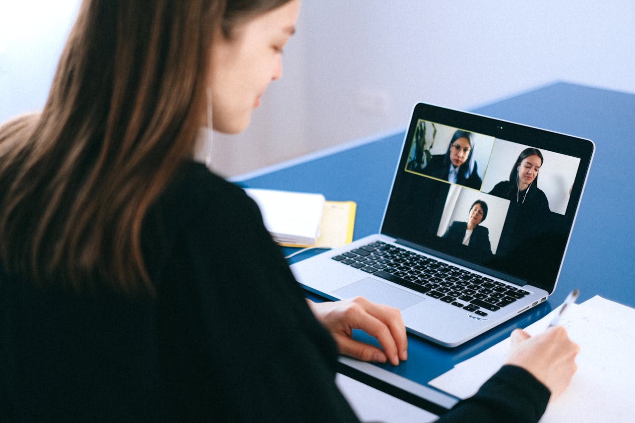 Woman on a video call with three colleagues