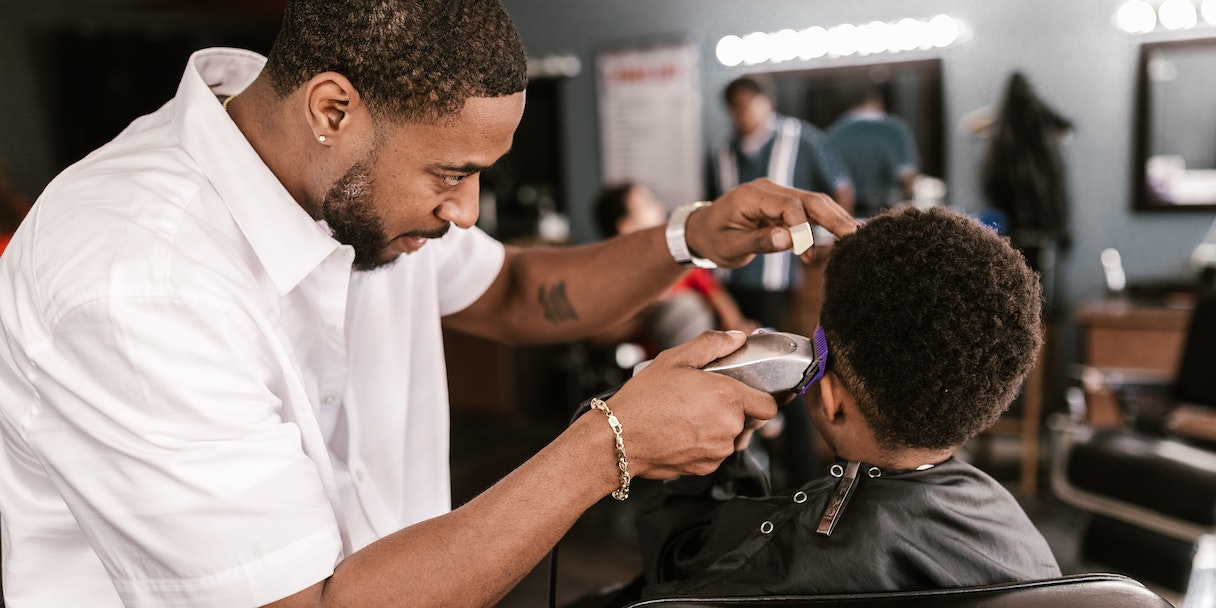 Barber giving a haircut to a young boy