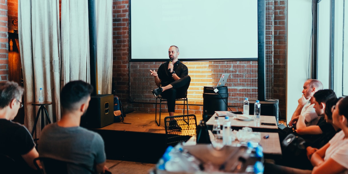 Man giving a talk to a seated audience