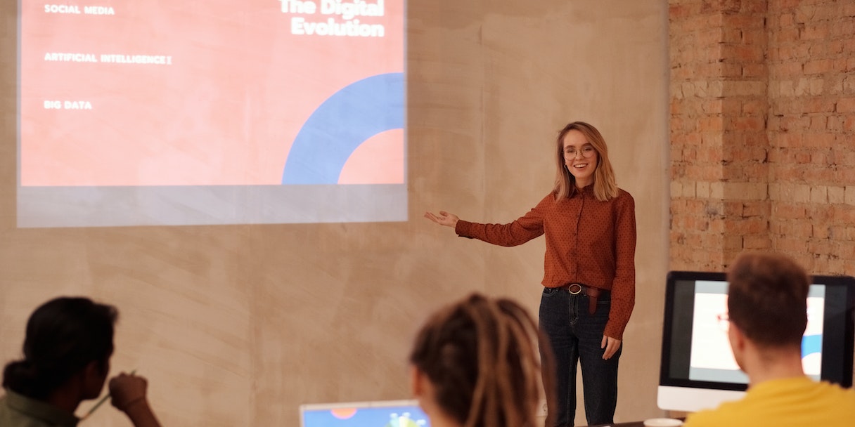 Woman presenting a digital evolution slide to a team