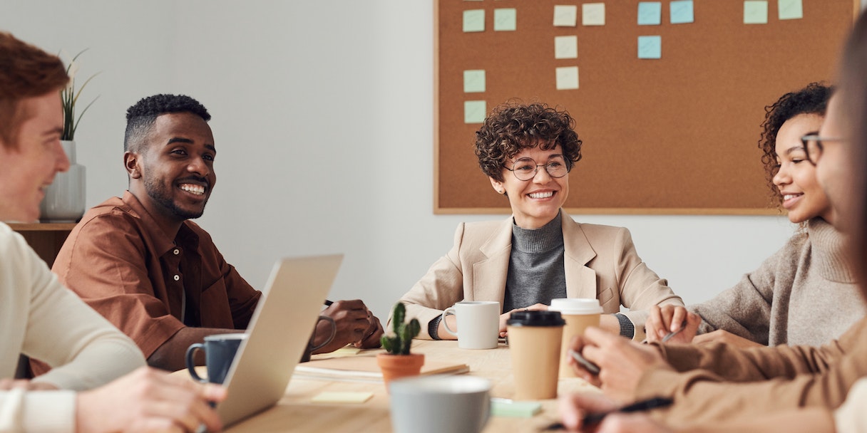 Team meeting around a table with coffee