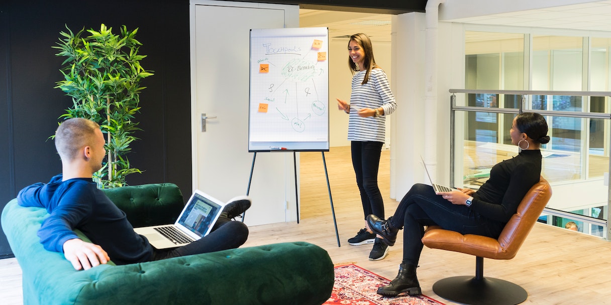 Woman presenting to colleagues in office