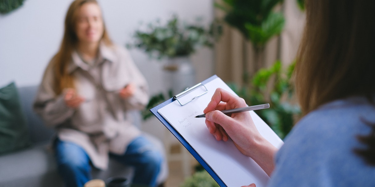 Therapist taking notes during a client session