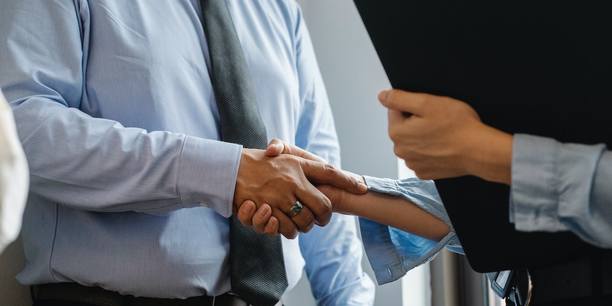 Two business people shaking hands