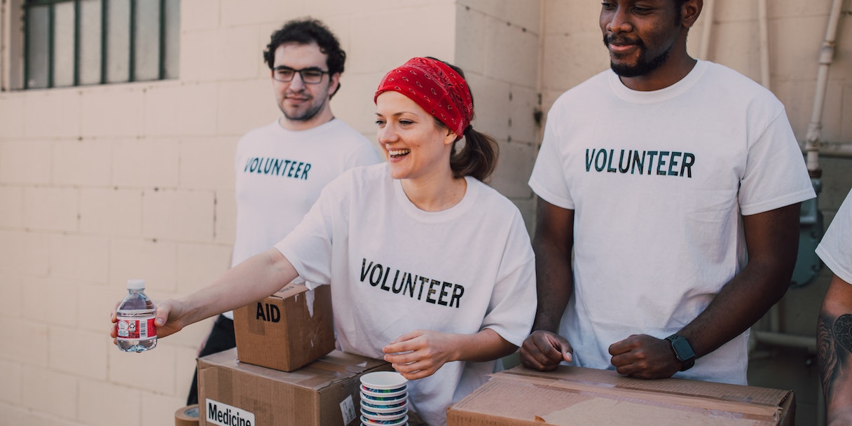 Volunteers in matching shirts packing aid supplies