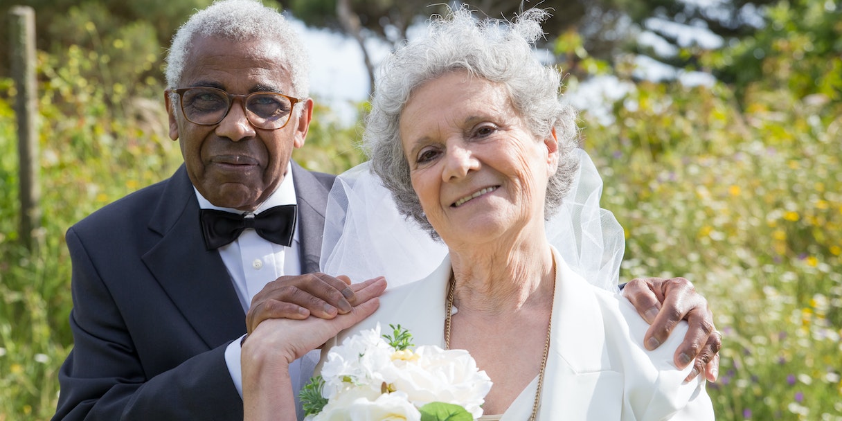 Elderly couple posing together at their wedding